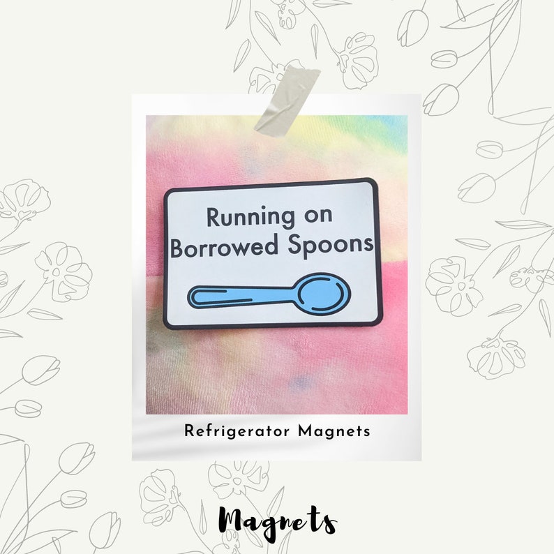 May include: A white refrigerator magnet with a blue spoon and the text "Running on Borrowed Spoons". The magnet is on a tie-dye background. Refrigerator Magnets.