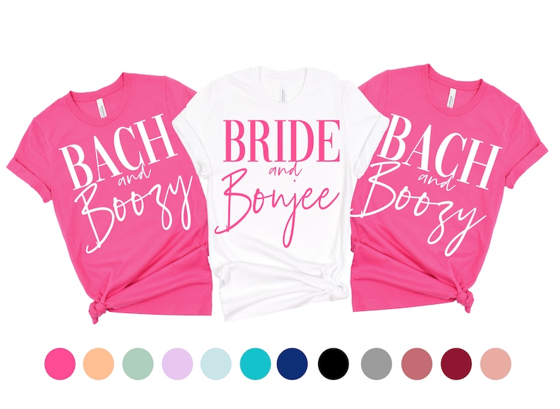 May include: Three pink and white t-shirts with the text "Bach and Boozy", "Bride and Bonjee", and "Bach and Boozy" printed on them. The shirts are arranged in a row, with the white shirt in the middle.