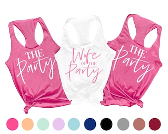 May include: Three tank tops with the text "The Party" in white on a pink background, and "Wife of the Party" in pink on a white background. The tank tops are arranged in a row, with the white tank top in the middle.