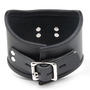 The Tall Curved Posture Collar With A Locking Buckle is shown from the back against a blank background, displaying the lockable silver buckle.