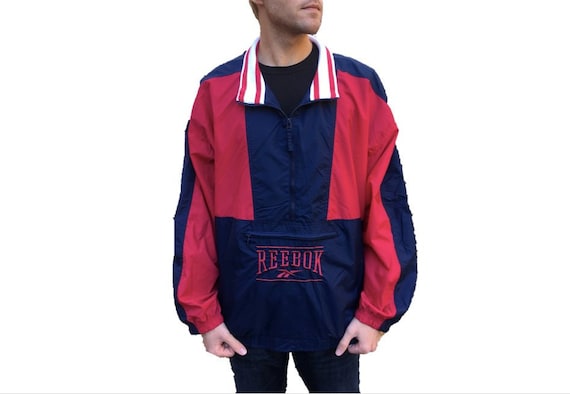 Vintage Windbreaker Jacket by Reebok Retro Dark Navy Blue w Red Geometric Color Block Designs Nylon Coat Men's Size XXL (2XL) Vintage Windbreaker Jacket by Reebok Retro Dark Navy Blue w Red Geometric Color Block Designs Nylon Coat Men's Size XXL (2XL)
