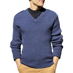 May include: A navy blue ribbed knit sweater with a v-neck and long sleeves. The sweater has a textured look and is made of a soft, comfortable material.