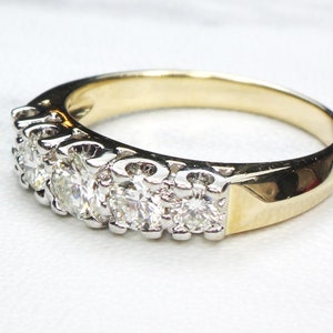 May include: A gold and silver band ring with a row of round, clear diamonds.