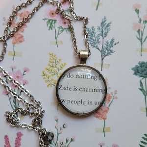 Zade is Charming pendant necklace made with Haunting Adeline book pages