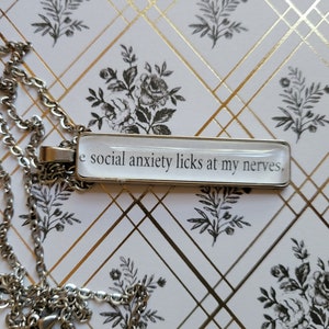 Social Anxiety pendant necklace made with Haunting Adeline book pages