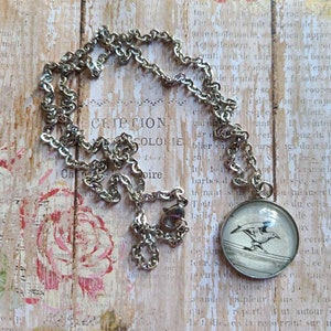 Revenir 20mm pendant necklace made with Invisible Life of Addie LaRue book pages