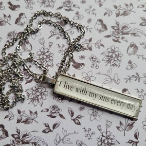I Live With My Sins pendant necklace made with An Ember in the Ashes book pages