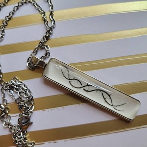 Vines pendant necklace made with Kingdom of the Feared book pages