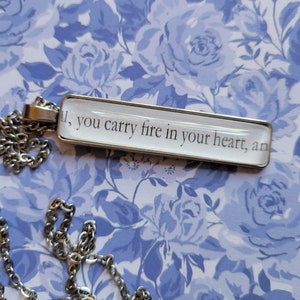 You Carry Fire in Your Heart pendant necklace made with Haunting Adeline book pages