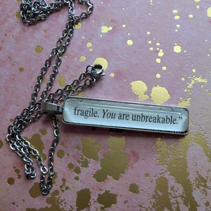 You Are Unbreakable pendant necklace made from Iron Flame book pages