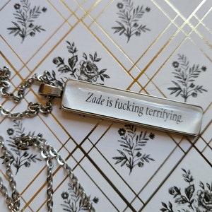 Zade is Terrifying pendant necklace made with Haunting Adeline book pages