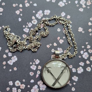 Swords pendant necklace made with King of Battle and Blood book pages