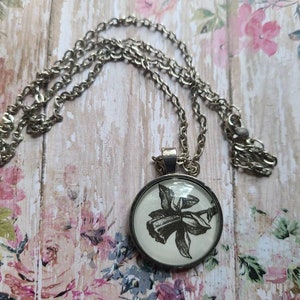 Narcissus pendant necklace made from Touch of Darkness book pages