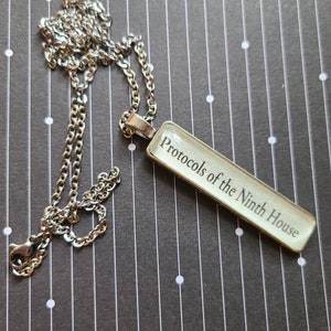 Protocols of the Ninth House pendant necklace made with Ninth House book pages