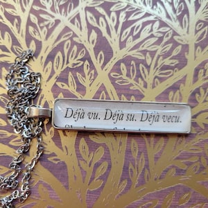 Deja Vu pendant necklace made with Invisible Life of Addie LaRue book pages