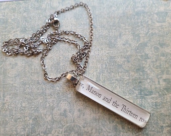 Manon and the Thirteen rectangle pendant necklace made with Throne of Glass book pages