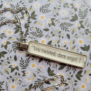 Twisted Dark Angel pendant necklace made with Kingdom of the Feared book pages