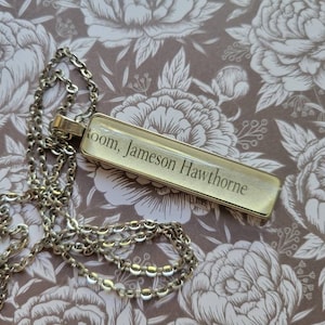 Jameson Hawthorne pendant necklace made with The Inheritance Games book pages