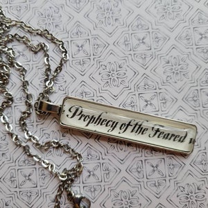 Prophecy pendant necklace made with Kingdom of the Feared book pages