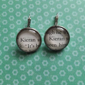 Kieran Contou pendant earrings made with From Blood and Ash book pages