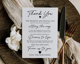 May include: A white card with black text that says "Thank You for sharing our special day and for your love and support. Along the way a new life together we now start and you have played a special part. You have helped to bring our dreams to life. Watched as we became husband and wife. So, we give our thanks and wishes, too. And all our love from us to you. Love, The Newlyweds."