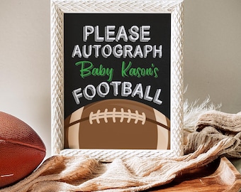 May include: White framed chalkboard sign with the text "PLEASE AUTOGRAPH Baby Kason's FOOTBALL" in green and white text. A brown and white football is pictured on the sign.