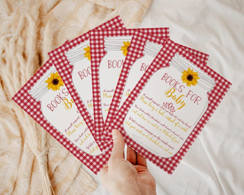 May include: Red and white gingham patterned cards with a mason jar illustration and the text "Books for Baby". The cards have a sunflower design and the text "A small request and we hope it's not too hard. Please bring a book, instead of a card."