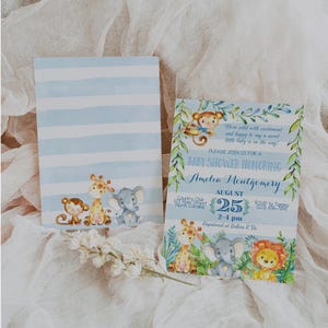 May include: A blue and green baby shower invitation with a jungle theme. The invitation features a giraffe, monkey, elephant, and lion. The text on the invitation reads "We're wild with excitement and happy to say a sweet little baby is on the way! Please join us for a baby shower honoring Amelia Montgomery August 25 2-4 pm Registered at Babies R Us"