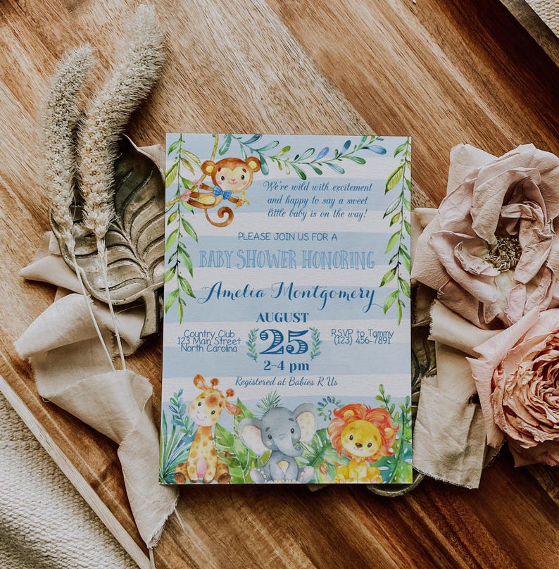 May include: A blue and white baby shower invitation with a jungle theme. The invitation features a monkey, giraffe, elephant, and lion. The text on the invitation reads "We're wild with excitement and happy to say a sweet little baby is on the way! Please join us for a baby shower honoring Amelia Montgomery. August 25, 2-4 pm. Country Club, 123 Main Street, North Carolina. Registered at Babies R Us."