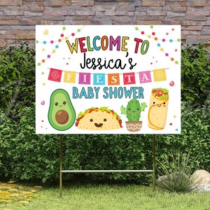May include: Welcome to Jessica's Fiesta Baby Shower yard sign with colorful decorations, a cartoon avocado, taco, cactus, and a burrito.