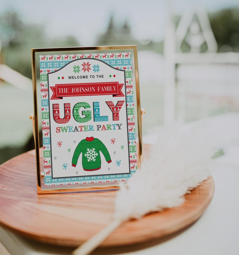 May include: A gold-framed sign with a white background and colorful Christmas sweater patterns. The sign reads "Welcome to the Johnson Family Ugly Sweater Party".