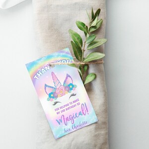 May include: A thank you tag with a unicorn illustration and a rainbow background. The text reads "Thank you for helping to make my 2nd birthday so magical! Love, Charlotte".