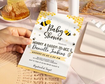 May include: A white baby shower invitation with a yellow and black honeycomb pattern. The invitation says "Baby Shower" and "Mommy & Daddy-to-Bee Danielle Jenkins". The date and time of the shower are August 25 at 2:00 PM. The location is Bellamy Country Club, 123 Main Street, North Carolina. The RSVP information is to Tessa at 123-456-7891 by August 15. The invitation also says "Registered at Target".