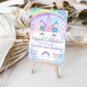 May include: A rainbow-themed invitation for a child's 2nd birthday party. The invitation features a unicorn with a rainbow and stars. The text reads "Over the Rainbow for a Magical Celebration Charlotte's 2nd Birthday!" with the date and time of the party.