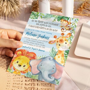 May include: A baby shower invitation featuring watercolor illustrations of jungle animals, including a lion, elephant, giraffe, and monkey. The invitation has text that reads "We are wild with excitement and happy to say, a sweet baby boy is on the way!"