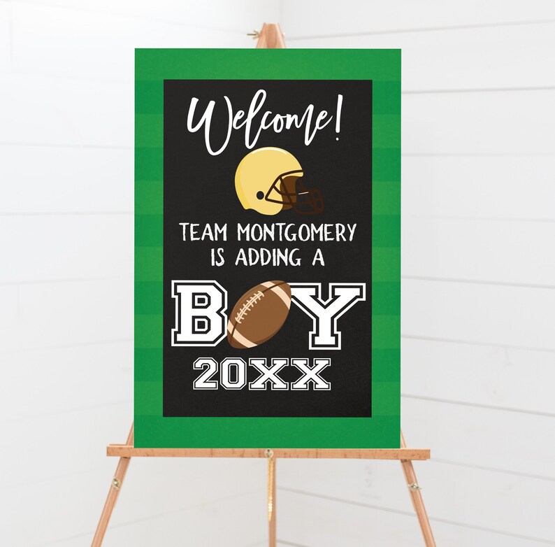 May include: A green and black chalkboard sign with white text announcing a baby boy. The sign says "Welcome! Team Montgomery is adding a BOY 20XX" with a football and a football helmet graphic.