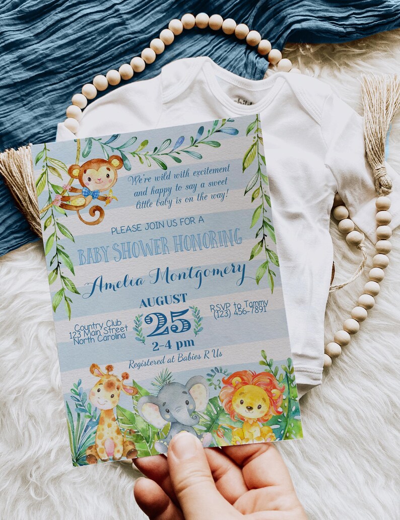 May include: A blue and white baby shower invitation with a jungle theme. The invitation features a monkey, giraffe, elephant, and lion. The text on the invitation reads "We're wild with excitement and happy to say a sweet little baby is on the way!"  "Please join us for a baby shower honoring Amelia Montgomery"  "August 25, 2-4 pm"  "Country Club, 123 Main Street, North Carolina"  "RSVP to Tammy (123) 456-7891"  "Registered at Babies R Us"