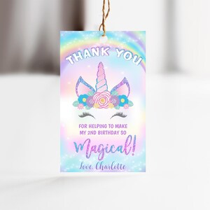 May include: A thank you tag with a unicorn illustration and rainbow background. The text reads "Thank You for helping to make my 2nd birthday so Magical! Love, Charlotte."