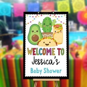 May include: Welcome to Jessica's Baby Shower sign with a black background and colorful text. The sign features a cartoon avocado, cactus, and burrito with smiling faces.