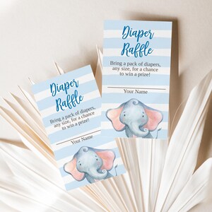 May include: Two baby shower raffle cards with blue and white striped backgrounds. The cards feature the text "Diaper Raffle" and "Bring a pack of diapers, any size, for a chance to win a prize!" An illustration of a gray elephant with pink ears is also present.