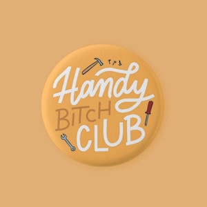 May include: A yellow button with the text "Handy Bitch Club" in white cursive lettering. The button is decorated with small drawings of tools, including a hammer, screwdriver, and wrench.