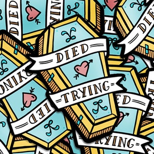 May include: A collection of colorful stickers featuring a coffin with the text "DIED TRYING" and a heart with an arrow. The stickers are in a variety of colors and designs, with some featuring a heart with an arrow and the text "DIED TRYING".