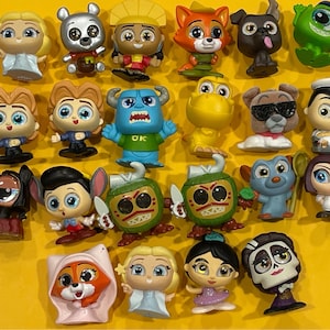 May include: A collection of 20 small, colorful, plastic figurines of popular cartoon characters. The characters include characters from Disney Pixar movies such as Toy Story, Monsters Inc., and Finding Nemo.