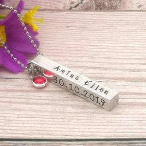 Personalised necklace - chunky metal bar personalised with baby name, birth date, birth time & birth weight. Choice of fonts. Birthstone crystal hangs next to bar. Shown on stainless steel ball chain. Aluminium metal, silver in colour, black letters.