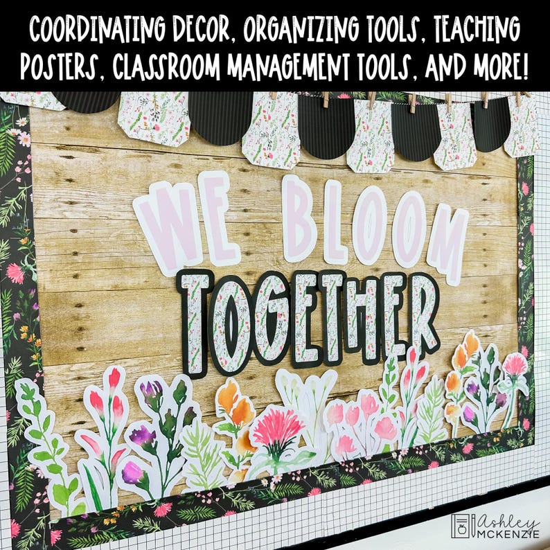 May include: A classroom bulletin board display featuring a wood-grain background, a floral border, and a banner with black and floral pennants. The text reads WE BLOOM TOGETHER in large letters, accented by colorful watercolor-style flower cutouts.