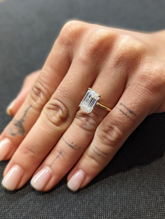 Forever One™ Emerald-Cut Moissanite Ring with Side-Stones