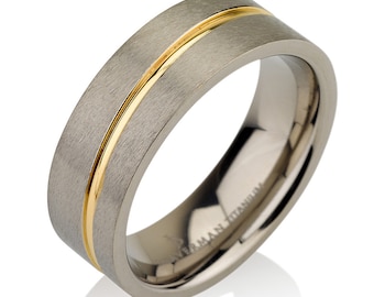 May include: A brushed titanium wedding band with a thin gold inlay. The band is a simple design with a smooth finish.
