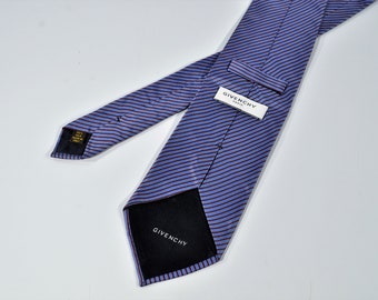 May include: A blue and burgundy striped silk tie with a black label that says "Givenchy Paris".
