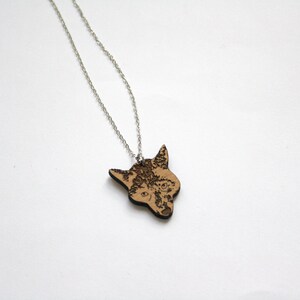 May include: A silver chain necklace with a wooden pendant featuring a detailed laser-engraved wolf head.