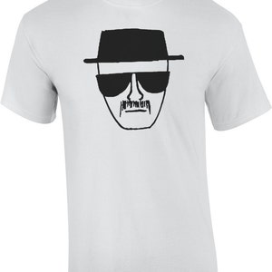 May include: White t-shirt with a black and white line drawing of Walter White's face from the TV show Breaking Bad.
